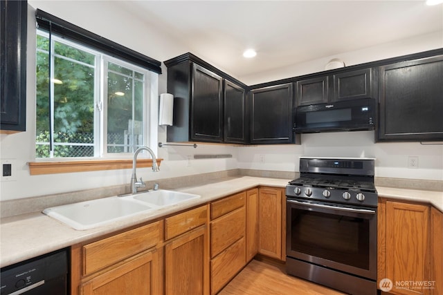 1625 Lincoln St, Bellingham, WA 98229 - kitchen with black appliances, light countertops, dark cabinets, light wood-style flooring, and brown cabinets