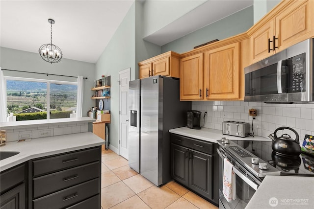2835 Aspen Shores Dr, East Wenatchee, WA 98802 - kitchen with stainless steel appliances, backsplash, light countertops, and light tile patterned floors