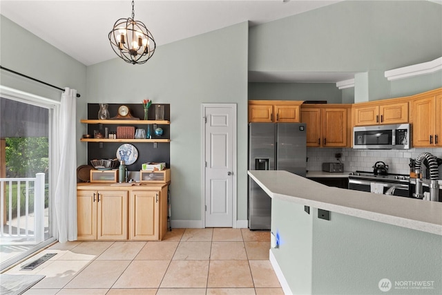 2835 Aspen Shores Dr, East Wenatchee, WA 98802 - kitchen featuring stainless steel appliances, light countertops, tasteful backsplash, hanging light fixtures, and lofted ceiling