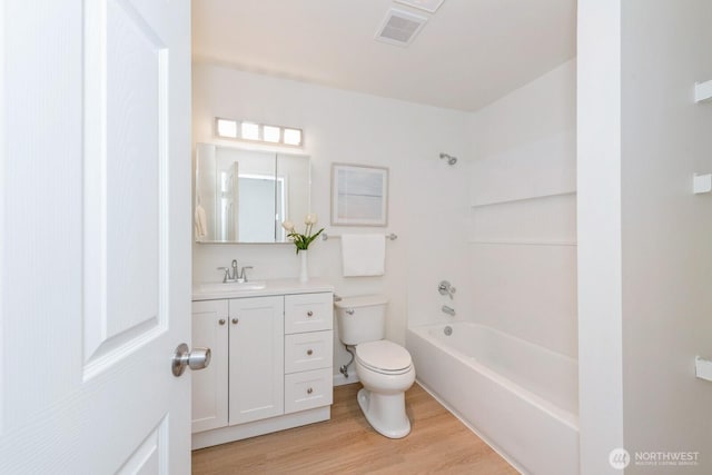 18505 SE Newport Way Unit E221, Issaquah, WA 98027 - full bath featuring vanity, wood finished floors, and tub / shower combination