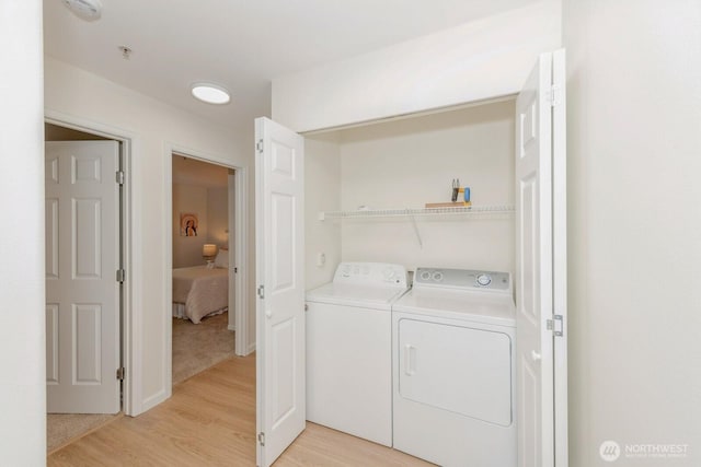 18505 SE Newport Way Unit E221, Issaquah, WA 98027 - laundry area featuring washing machine and clothes dryer and light wood-style floors