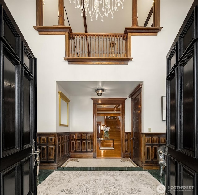 1214 Warren Ave N, Seattle, WA 98109 - entrance foyer with wainscoting, a towering ceiling, and a chandelier