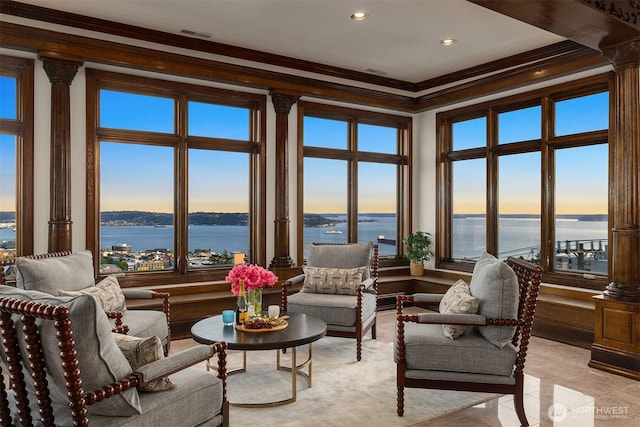 1214 Warren Ave N, Seattle, WA 98109 - living area featuring crown molding, a water view, recessed lighting, and decorative columns