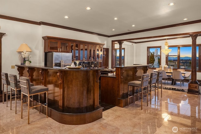 1214 Warren Ave N, Seattle, WA 98109 - indoor wet bar featuring stainless steel refrigerator with ice dispenser, crown molding, recessed lighting, ornate columns, and pendant lighting