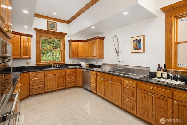 1214 Warren Ave N, Seattle, WA 98109 - kitchen with dishwasher, brown cabinets, ornamental molding, recessed lighting, and dark countertops