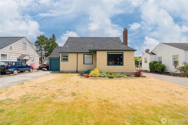 1028 20th Ave, Longview, WA 98632 - bungalow-style home featuring driveway, a chimney, a front yard, and a shingled roof