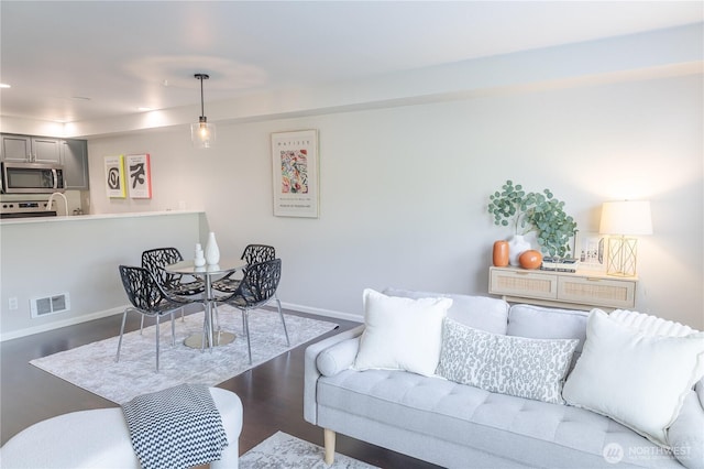 559 Mcgraw St Unit 204, Seattle, WA 98109 - living room featuring baseboards and wood finished floors