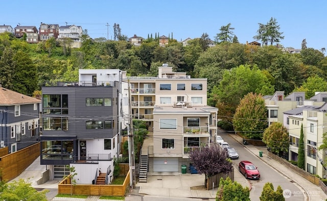 559 Mcgraw St Unit 204, Seattle, WA 98109 - view of property featuring an attached garage, driveway, and stairway