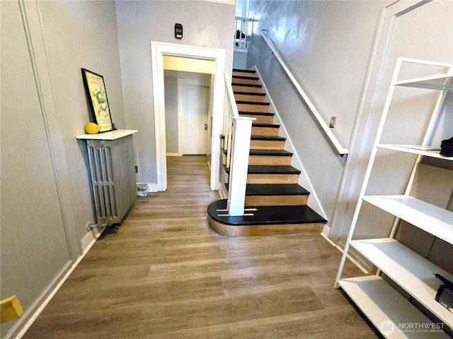 4715 19th Ave NE, Seattle, WA 98105 - stairs featuring wood finished floors and radiator heating unit