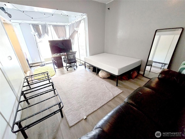 4715 19th Ave NE, Seattle, WA 98105 - living area featuring wood finished floors, baseboard heating, and an office area