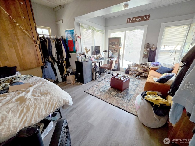4715 19th Ave NE, Seattle, WA 98105 - bedroom featuring wood finished floors, a walk in closet, a closet, and an office area