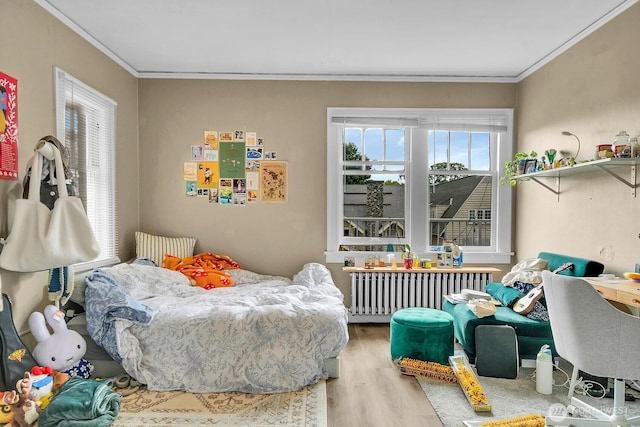 4715 19th Ave NE, Seattle, WA 98105 - bedroom featuring radiator, wood finished floors, and crown molding