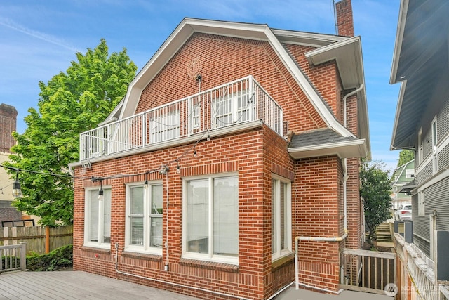 4715 19th Ave NE, Seattle, WA 98105 - view of home's exterior featuring brick siding, a balcony, and a chimney