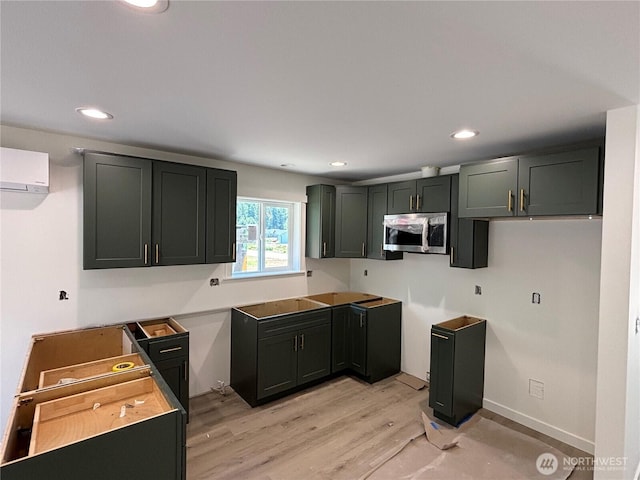8256 Gold Run Dr, Maple Falls, WA 98266 - kitchen featuring stainless steel microwave, a wall mounted AC, light wood-style flooring, and recessed lighting