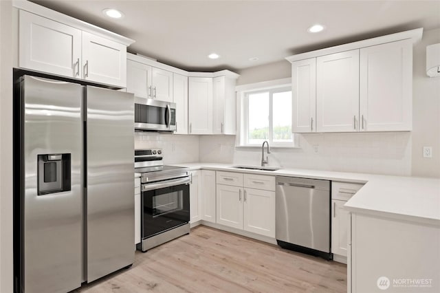 8256 Gold Run Dr, Maple Falls, WA 98266 - kitchen featuring appliances with stainless steel finishes, recessed lighting, white cabinets, light wood finished floors, and decorative backsplash