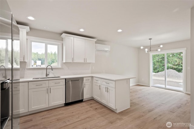 8256 Gold Run Dr, Maple Falls, WA 98266 - kitchen with dishwasher, a peninsula, decorative backsplash, white cabinets, and light wood-type flooring