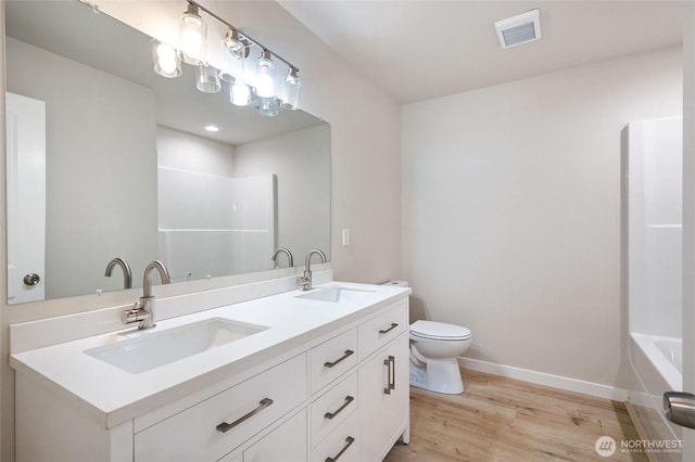 8256 Gold Run Dr, Maple Falls, WA 98266 - full bath featuring double vanity, wood finished floors, and washtub / shower combination