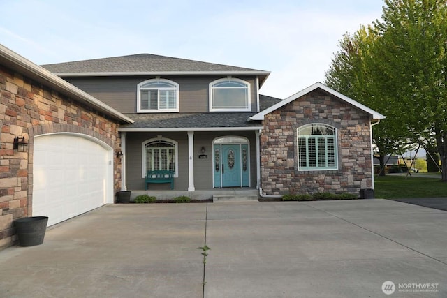 12003 Summit Haven Pl, Yakima, WA 98908 - view of front of home featuring a porch, stone siding, concrete driveway, roof with shingles, and an attached garage
