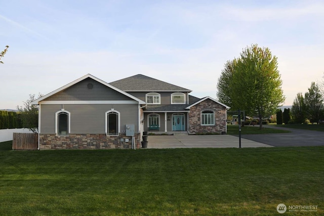 12003 Summit Haven Pl, Yakima, WA 98908 - view of front of property with stone siding, a front yard, and covered porch