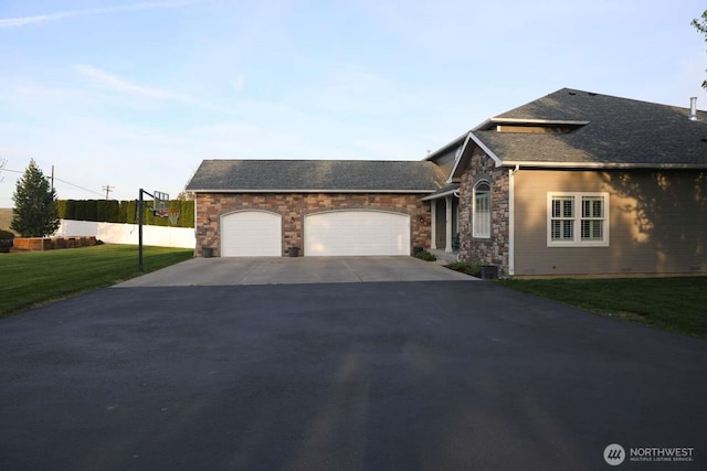 12003 Summit Haven Pl, Yakima, WA 98908 - view of front of home with asphalt driveway, an attached garage, a front yard, stone siding, and roof with shingles