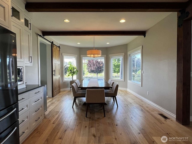12003 Summit Haven Pl, Yakima, WA 98908 - dining area featuring beam ceiling, a barn door, light wood finished floors, and recessed lighting