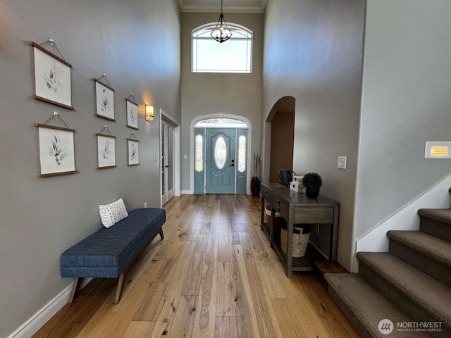 12003 Summit Haven Pl, Yakima, WA 98908 - foyer with arched walkways, light wood-style flooring, healthy amount of natural light, ornamental molding, and a high ceiling