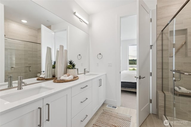 12257 137th Pl NE Unit 2901, Redmond, WA 98052 - ensuite bathroom with double vanity, a shower stall, and recessed lighting