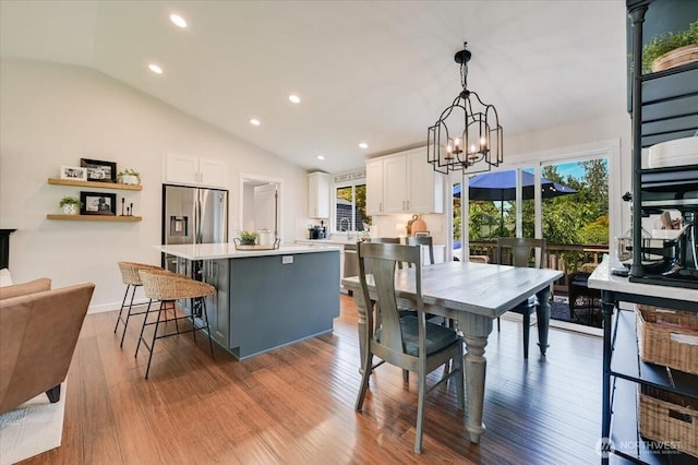 26908 NE Bird St, Duvall, WA 98019 - dining space featuring recessed lighting, vaulted ceiling, a chandelier, and wood finished floors