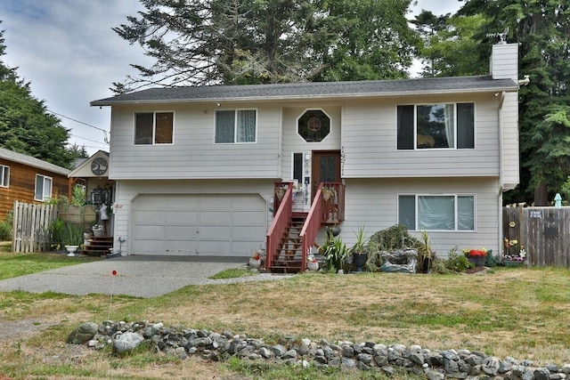 1271 Rickover Dr, Coupeville, WA 98239 - bi-level home with a garage, a chimney, and driveway