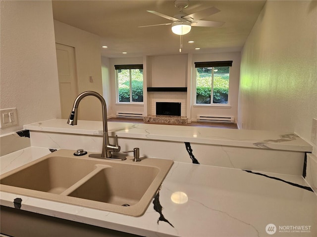509 S 323rd Pl Unit 15E, Federal Way, WA 98003 - kitchen featuring healthy amount of natural light, light stone countertops, ceiling fan, recessed lighting, and a textured wall