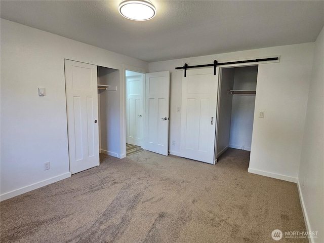 509 S 323rd Pl Unit 15E, Federal Way, WA 98003 - unfurnished bedroom featuring carpet flooring and a barn door