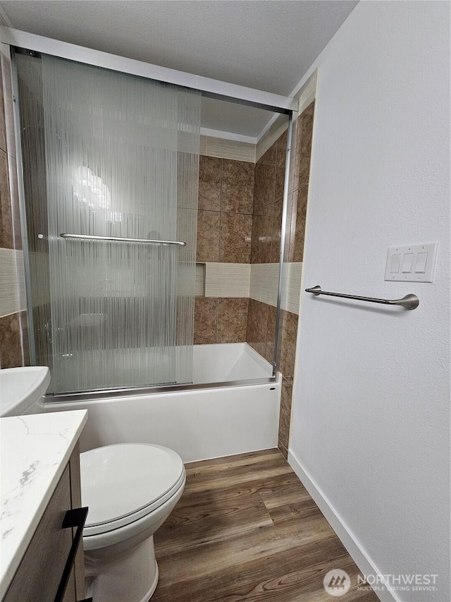 509 S 323rd Pl Unit 15E, Federal Way, WA 98003 - full bath featuring vanity, wood finished floors, and shower / bath combination with glass door