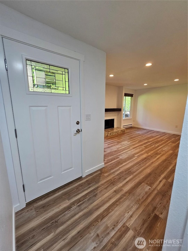 509 S 323rd Pl Unit 15E, Federal Way, WA 98003 - foyer with a fireplace with raised hearth, wood finished floors, and recessed lighting