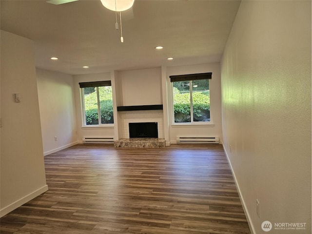 509 S 323rd Pl Unit 15E, Federal Way, WA 98003 - unfurnished living room with plenty of natural light, baseboard heating, recessed lighting, and dark wood-type flooring