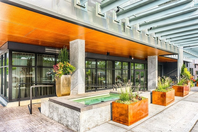 1085 103rd Ave NE Unit 217, Bellevue, WA 98004 - property entrance featuring an in-ground hot tub and a patio