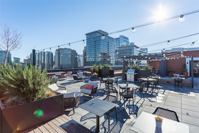 1085 103rd Ave NE Unit 217, Bellevue, WA 98004 - view of patio / terrace with a skyline view and an outdoor living space