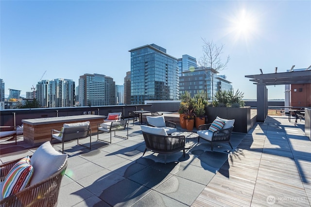 1085 103rd Ave NE Unit 217, Bellevue, WA 98004 - view of patio with an outdoor living space, a skyline view, and a pergola