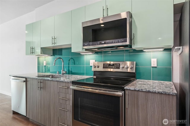 1085 103rd Ave NE Unit 217, Bellevue, WA 98004 - kitchen with stainless steel appliances, stone counters, tasteful backsplash, and wood finished floors