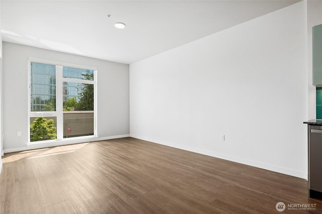 1085 103rd Ave NE Unit 217, Bellevue, WA 98004 - spare room with wood finished floors and baseboards