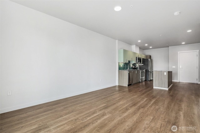 1085 103rd Ave NE Unit 217, Bellevue, WA 98004 - unfurnished living room featuring dark wood-style flooring and recessed lighting