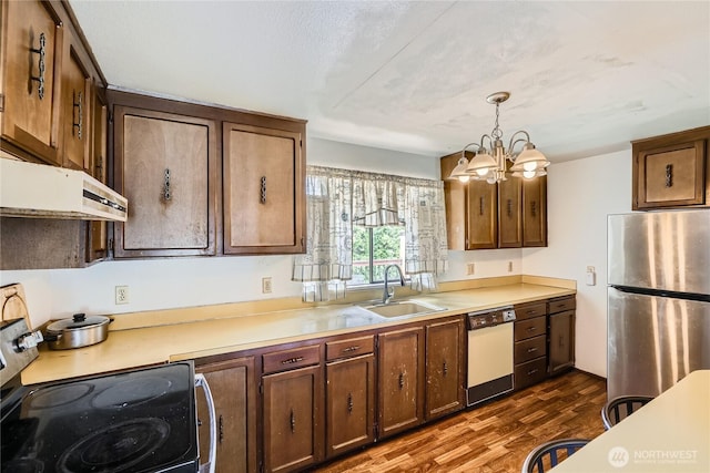 2708 NE 106th Pl, Seattle, WA 98125 - kitchen featuring freestanding refrigerator, dishwasher, electric stove, a chandelier, and light countertops