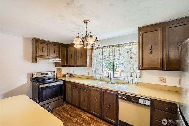 2708 NE 106th Pl, Seattle, WA 98125 - kitchen with white dishwasher, electric range, under cabinet range hood, a chandelier, and light countertops