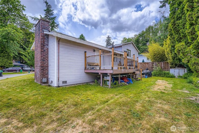 2708 NE 106th Pl, Seattle, WA 98125 - rear view of house with a chimney, a wooden deck, a yard, and a storage shed