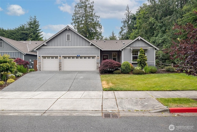 700 Twin Brooks Dr, Mount Vernon, WA 98273 - view of front facade with board and batten siding, an attached garage, concrete driveway, a front lawn, and stone siding