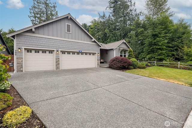 700 Twin Brooks Dr, Mount Vernon, WA 98273 - view of front of house featuring stone siding, concrete driveway, an attached garage, and board and batten siding