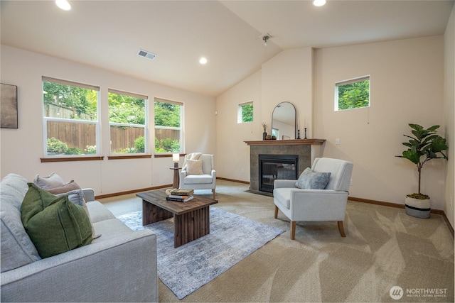 700 Twin Brooks Dr, Mount Vernon, WA 98273 - living area featuring healthy amount of natural light, vaulted ceiling, a tiled fireplace, light colored carpet, and recessed lighting