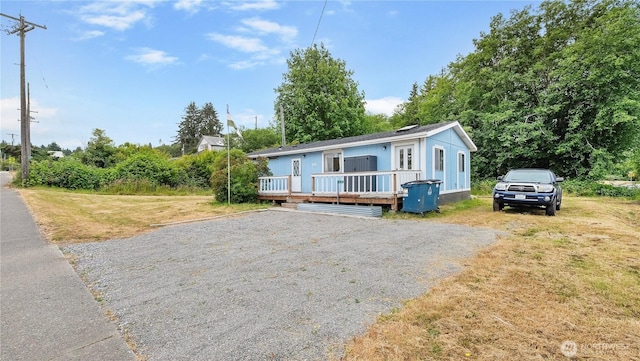 16880 Hwy 112, Clallam Bay, WA 98326 - view of front of home featuring a deck, driveway, and a front lawn