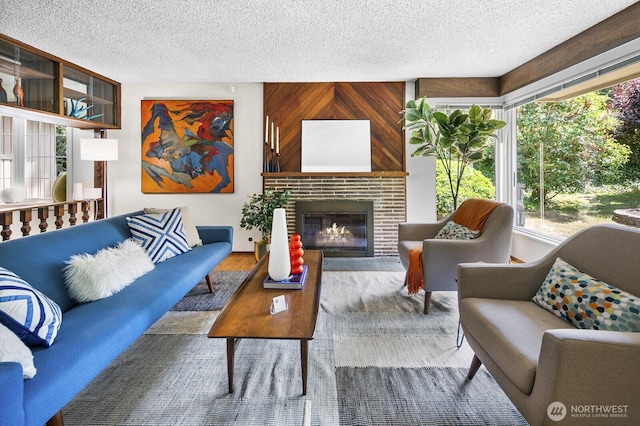 852 NE 194th St, Shoreline, WA 98155 - living area with a textured ceiling, healthy amount of natural light, wood finished floors, and a brick fireplace