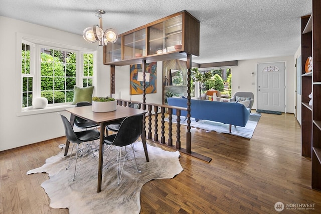 852 NE 194th St, Shoreline, WA 98155 - dining room featuring a chandelier, a textured ceiling, and wood finished floors