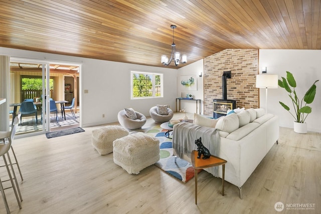 852 NE 194th St, Shoreline, WA 98155 - living room featuring a wood stove, vaulted ceiling, wooden ceiling, a chandelier, and wood finished floors